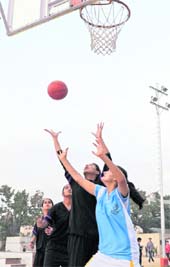 Players in action during the Senior State Basketball Championship at New Public School, Sector-18, Chandigarh