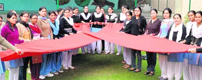Members of the NSS unit of Dev Samaj College of Education observe World AIDS Day in Chandigarh on Thursday