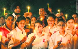 Students of DAV School, Sector 15, and members of the Young Accord, an NGO, hold a candle-lit vigil to mark the World AIDS Day at Sector 17, Chandigarh, on Thursday.