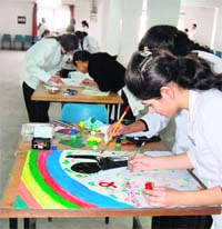 Students of SGRR Medical College make posters on World AIDS Day in Dehradun on Thursday.
