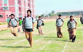 Students of JK Business School participate in a sack race