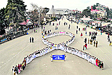 Nurses form a human chain on World AIDS Day at the Ridge in Shimla on Thursday.