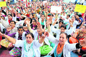Members of the Rajindra Hospital Joint Action Committee hold a protest in support of their demands in Patiala on Thursday. 