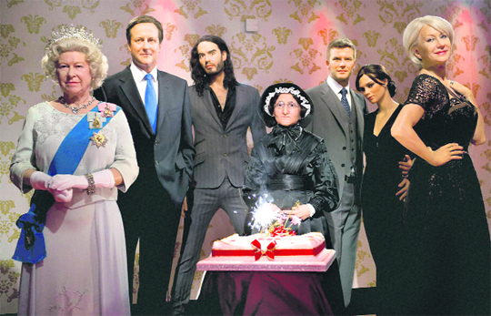 To mark the 250th birthday of Madame Marie Tussaud, the French founder of Londons Madame Tussauds, her waxwork (centre) is posed with those of prominent British personalities. (From left): Queen Elizabeth II, @@Prime Minister David Cameron, actor Russell Brand, footballer David Beckham and his wife Victoria Beckham and actor Helen Mirren, at Madame Tussauds in London on Thursday. 