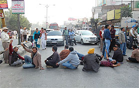 Demanding that vacant posts of multi-purpose worker be advertised, members of the Unemployed Multi-purpose Health Workers (Male) Union, Punjab, block vehicular traffic near bus stand in Bathinda on Friday. 