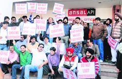 Applicants stage a protest against Ansal API in Chandigarh on Friday