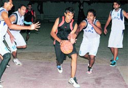 Players grapple for the ball during the basketball tournament at Sector 18, Chandigarh, on Friday