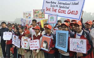 Schoolchildren participate in the mini marathon for a Save the girl child campaign at the Sports Stadium in Sector 12, Faridabad, on Friday. 
