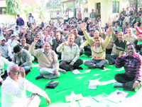 Employees of the Peyjal Nigam hold a demonstration on the 17th day of their strike in Dehradun on Friday. 