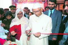 Governor Jagannath Pahadia, accompanied by his wife, inaugurates a state-level exhibition depicting development in Haryana at Gita Jayanti Samaroh-2011 being celebrated in Kurukshetra on Friday. 