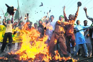 ANGRY VOICES: Protesters in Lahore burn an effigy of US President Barack Obama on Friday.