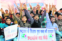 Members of the Youth Against Corruption stage a protest in Jammu on Friday. 