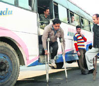 A differently abled person alights from a bus at Bikram Chowk in Jammu. 