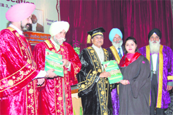Supreme Court Judge Justice DK Jain presents a degree to a student at the Khalsa College convocation in Amritsar on Saturday.