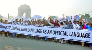 Hearing impaired people take part in a rally on the occasion of World Disability Day at India Gate in New Delhi on Saturday