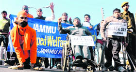 Physically challenged persons take out a rally in Jammu on Saturday.