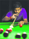 A player aims a shot during the Punjab State Snooker Championship in Ludhiana