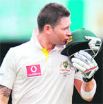 Australias captain Michael Clarke kisses his helmet after scoring a century against New Zealand in the Test match in Brisbane 
