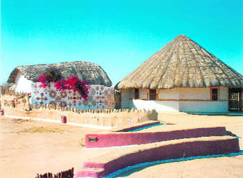 These circular and thatched huts are called bhungas. The walls of the huts have intricate mud-and-mirror work of Gujarat, giving an understated elegance to these mud-plastered structures