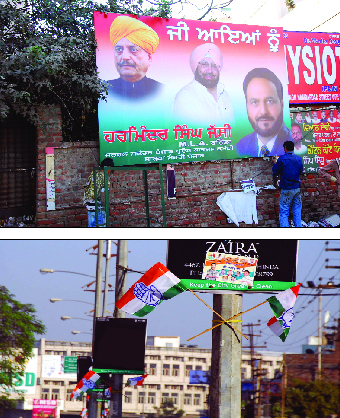 A worker (above) puts up a hoarding related to the Congress rally, in Bathinda on Sunday; Congress flags have come up across the city as political activity hots up in the region ahead of Assembly elections. 