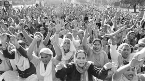 Members of the Democratic Midday Meal Cook Front, Punjab, participate at a rally in Mohali on Sunday. 