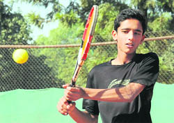 Rohit Dhiman returns a shot against Ayush in Chandigarh on Sunday.