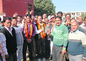 Mukesh Bassi of the Congress with supporters at Sector 21 in Chandigarh on Sunday. 