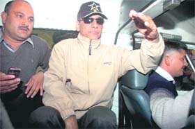 Satpal Singh, DIG, ITBP, (with cap) is taken to a court by CBI personnel in Dehradun on Sunday