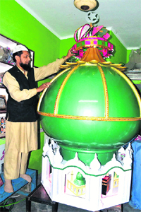 An artist prepares a tazia at Jwalapur in Haridwar on Sunday. 