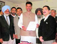 Congress candidate from Nalagarh Lakhwinder Rana receives the victory certificate in Nalagarh on Sunday.