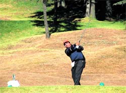 A golfer tees off during a golf tournament at Naldehra near Shimla on Sunday