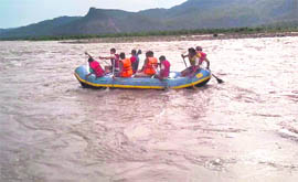 Tourists enjoy rafting in the Chenab at Reasi on Sunday.