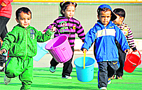 Kids participate in the bucket race at the annual sports day of a school in Ludhiana on Sunday.