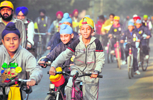 Kids take part in a cycle rally to raise awareness on protecting environment in Ludhiana on Sunday.