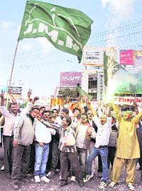 Party workers of the Jharkhand Mukti Morcha celebrate after retaining the Mandu Assembly seat in Ranchi on Sunday