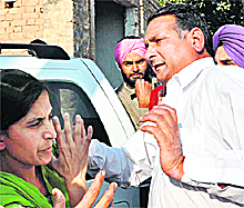 An Akali sarpanch raises his hand at a woman teacher at Daula village in Gidderbaha. 