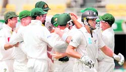 New Zealands Ross Taylor (R) walks back after being dismissed by Australias James Pattinson in Brisbane on Sunday