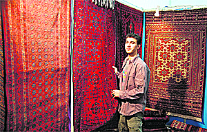 Mohammed Ishaq from Afghanistan shows woollen carpets 
