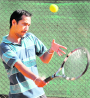 A player in action during a tennis match at Sector 11 in Chandigarh on Monday.