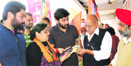 Ward 9 candidate Inderjit Kaur Kang, flanked by her sons Simran Kang and Preet Raj Kang, during a poll campaign at the Sector-40 market in Chandigarh on Monday.