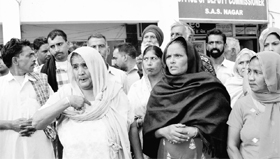 A resident of Nanu Majra village narrates her ordeal outside the office of the Mohali Deputy Commissioner.