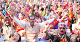 Class IV employees of the state government hold a dharna at the Parade Ground in Dehradun on Monday. 