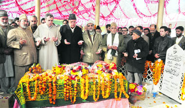 Chief Minister Omar Abdullah and Union minister Farooq Abdullah along with other state ministers pay tributes to Sheikh Mohammad Abdullah at his grave in Srinagar on Monday.