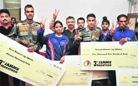 The winners of the 3rd Jammu Marathon at a press conference in Jammu on Monday