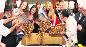 Six beauty pageant winners from across the world take part in a cake-mixing ceremony at a hotel in Ludhiana on Monday