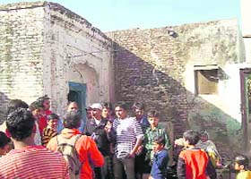 Villagers gather outside Dev Anands ancestral house in Gharota village of Gurdaspur
