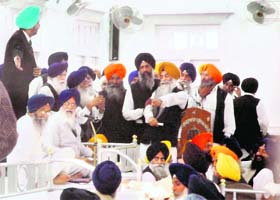 Ruling and Opposition members of the SGPC exchange an argument during the first House meeting at Teja Singh Samundari Hall in Amritsar on Monday