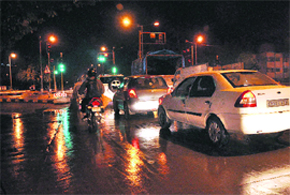 Motorists drive after the first rain this winter in Chandigarh on Tuesday evening.