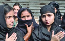 Shia women mourn during a Moharram procession in New Delhi on Tuesday