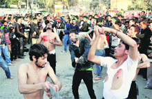 Muslims flay themselves with iron chains during a Moharram procession in Dehradun on Tuesday. 